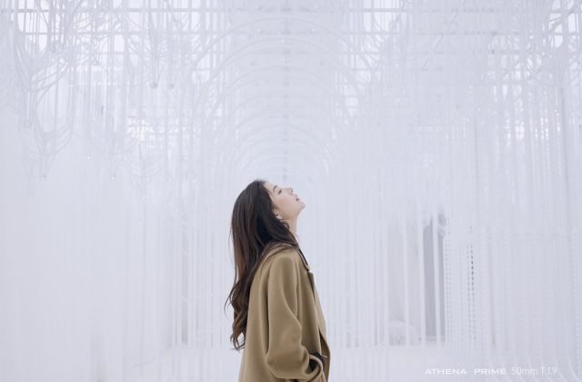 Woman in a corridor of white threads, shot with an Athena Prime