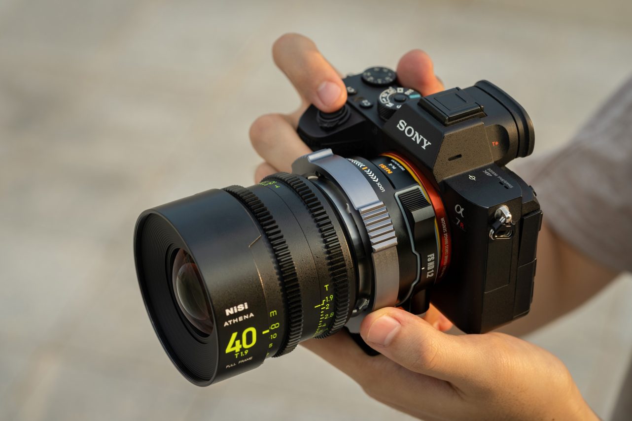 Hands holding a Sony camera with an ATHENA 40mm lens on the NiSi Drop-In Filter PL Mount Adapter